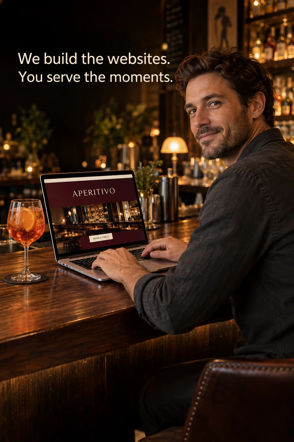 A bar owner working on the venue website on a laptop